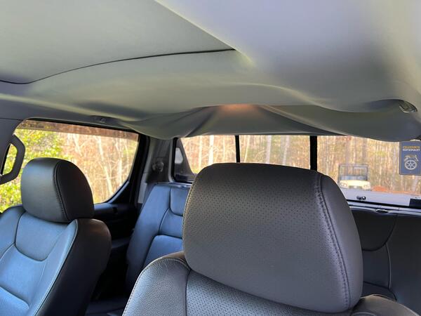 Before: The interior of a truck with a sagging truck headliner