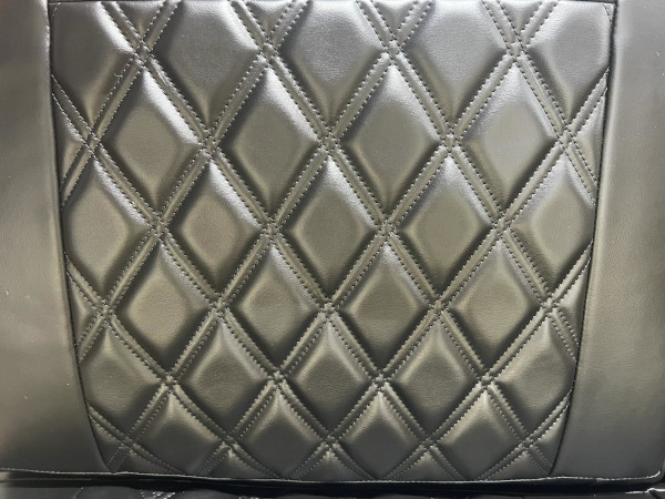 After: Closeup of a doublestiched diamond-pattern leather-covered vehicle bench seat.