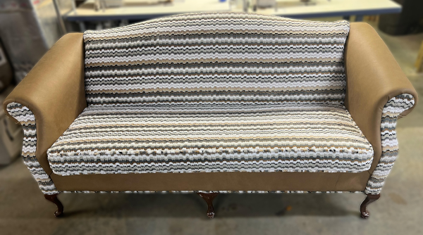After: Antique loveseat with new modern fabric pattern.