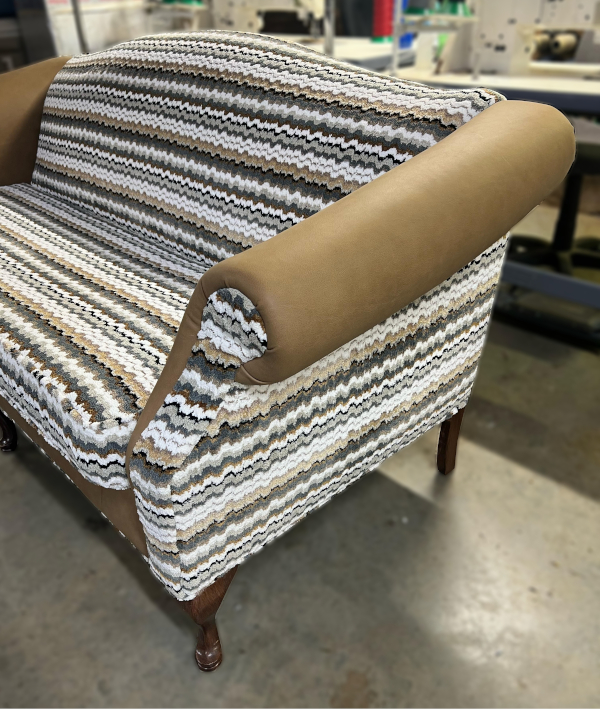 After: Sideview of an antique loveseat with new modern fabric pattern.