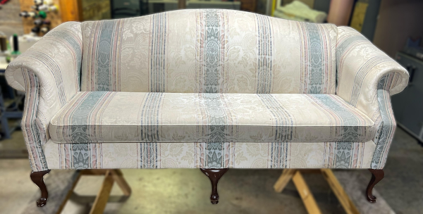 Before: Antique loveseat with aging fabric pattern.