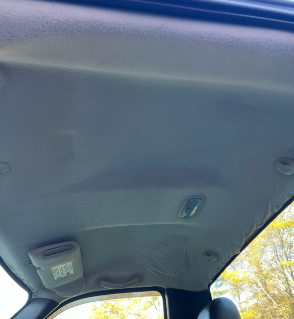 Before:  A truck with an aging headliner.  The headliner has thumb tacks lining the back edge, and a section which is held up by many thumb tacks.