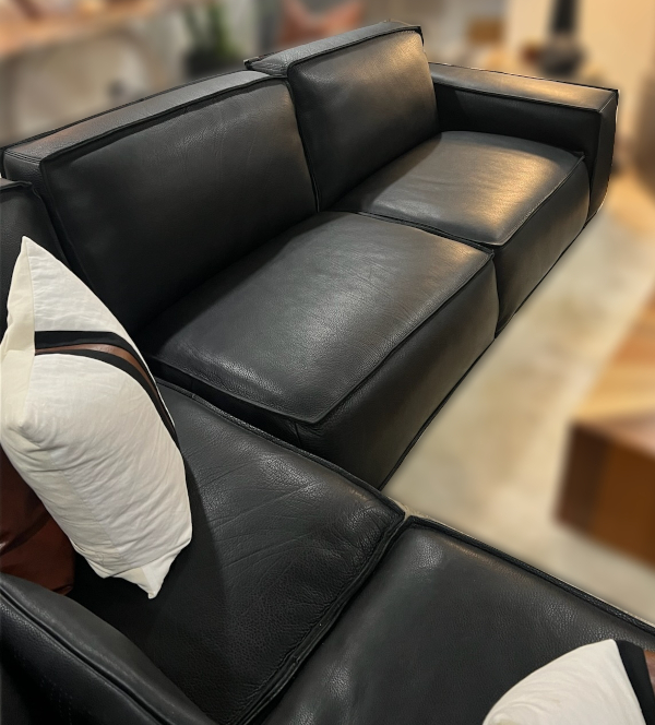 After: Picture of a lovely leather couch after having been fixed and restuffed to like-new condition.