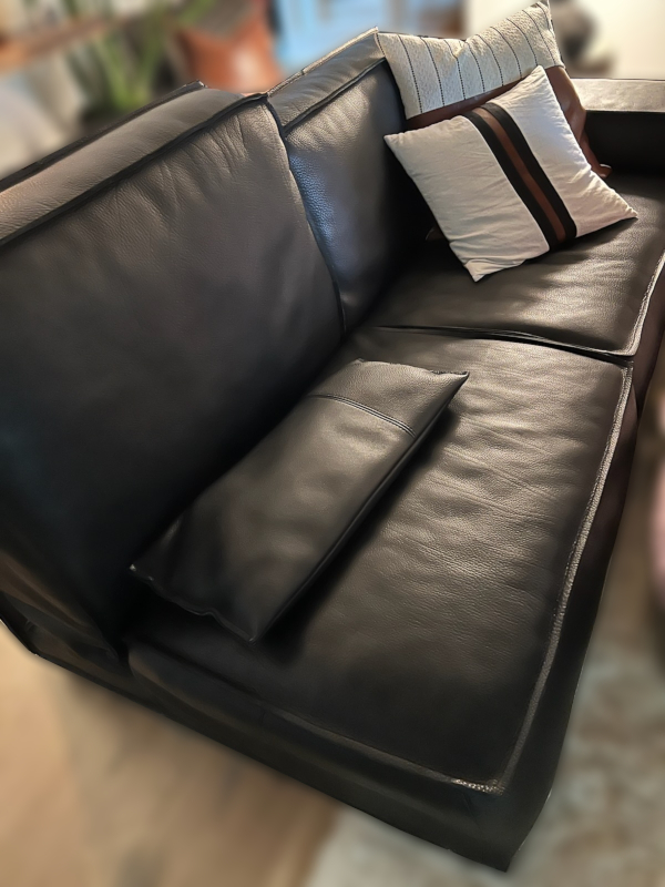 Before: Picture of a lovely leather couch with wrinkling from worn-out padding.
