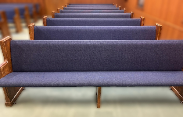 After: Row of church pews with new blue covering.  All padding lines are smooth and good-looking.